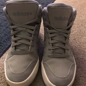 Gray and white women’s Adidas sneakers